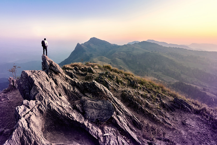 A person standing on top of a mountain